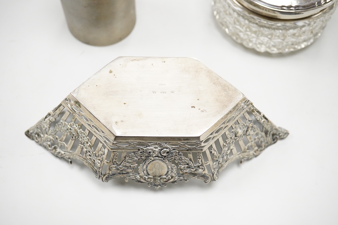 A German pierced 800 standard white metal bowl, 21.2cm, an engine turned white metal cigarette canister and a silver mounted glass dressing table pot.